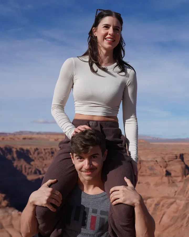 Isabelle Marrone sitting on Evan Marrone's shoulders at a canyon overlook, both smiling